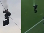 A camera plunges to the ground in the middle of a football match, narrowly avoiding disaster
