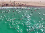 One week after a near-fatal shark attack in Sydney, thousands gather to swim on the same beach in emotional tribute